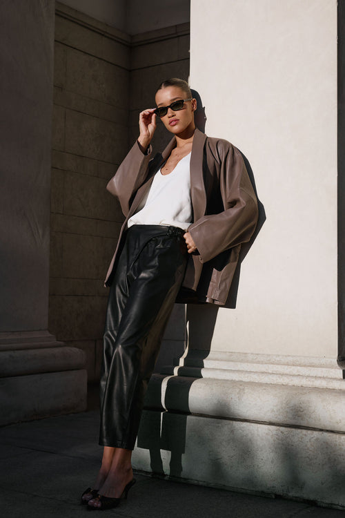 Black cropped leather pants with buckle detail